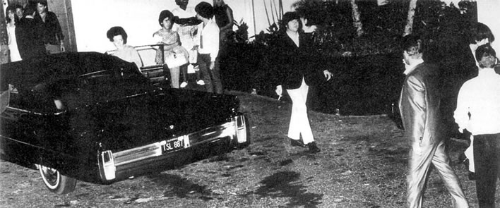 The Beatles meet Elvis Presley.